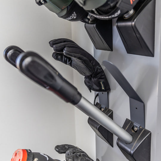 A close up of leather snow gloves drying on the Koralp Stokdry Dryer using the solid metal glove attachment.